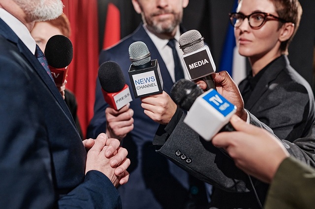 Journalisten mit I-Visum interviewen Geschäftsmann auf Konferenz